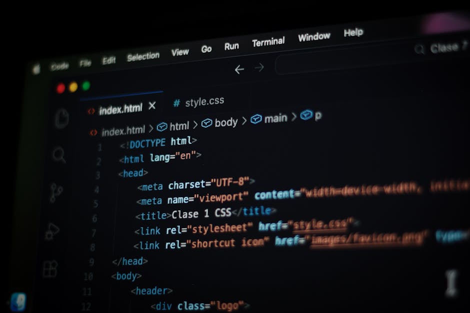 The image displays a close-up view of a computer screen with lines of programming code written in HTML and CSS. The code includes colorful tags and attributes, such as '<h1>', '<div>', and '<img>', wi